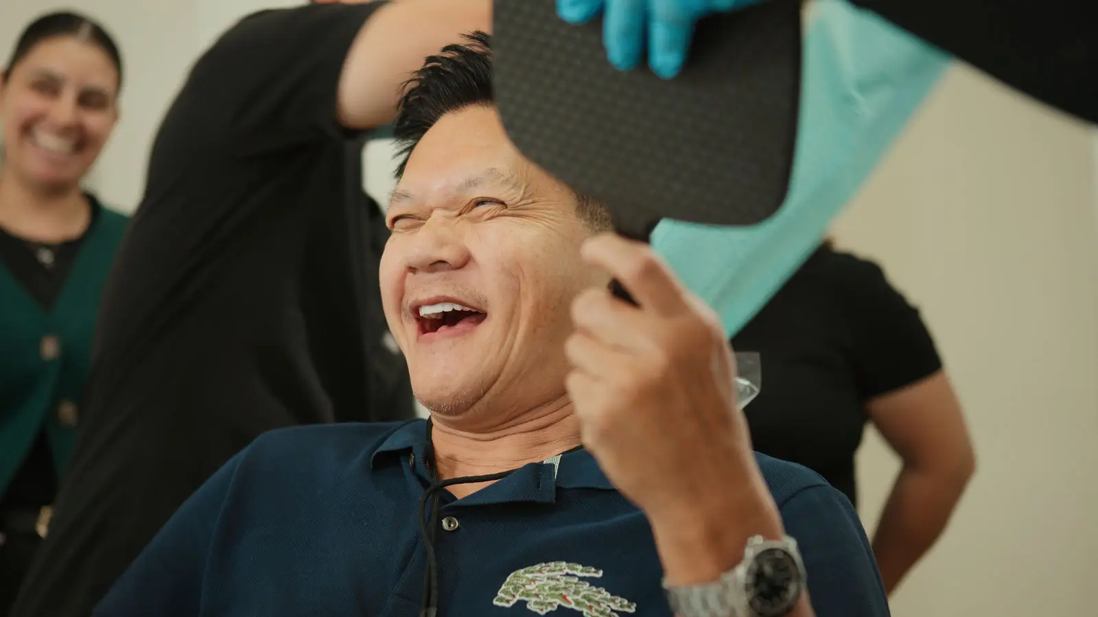 Patient checking his new smile in the mirror