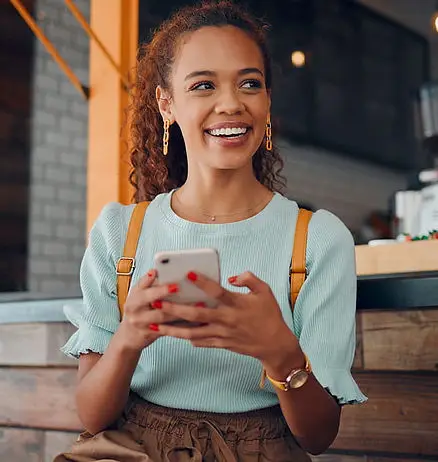 Smiling woman holding her phone